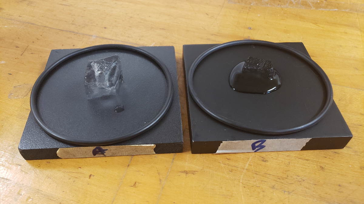 Ice melting on two black blocks made from different materials