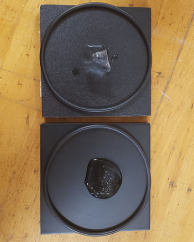 Ice melting on two black blocks made from different materials