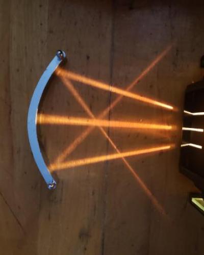 three rays of light converging as they are reflected by a curved mirror